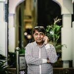 Man Standing While Talking on Phone